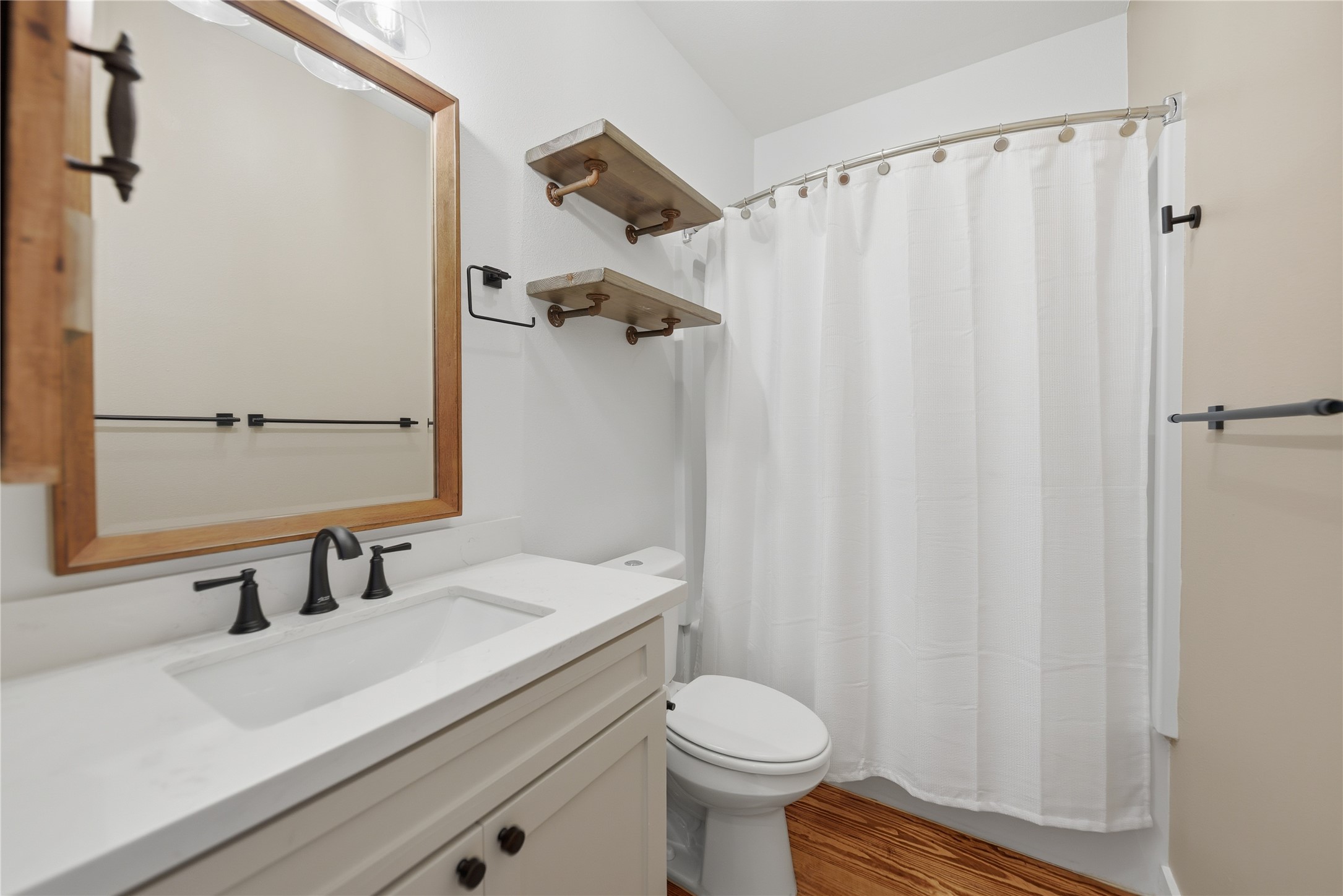 704 Burleson Street Brenham, TX 77833 - Photo 23 of 28 a bathroom with a sink and a mirror