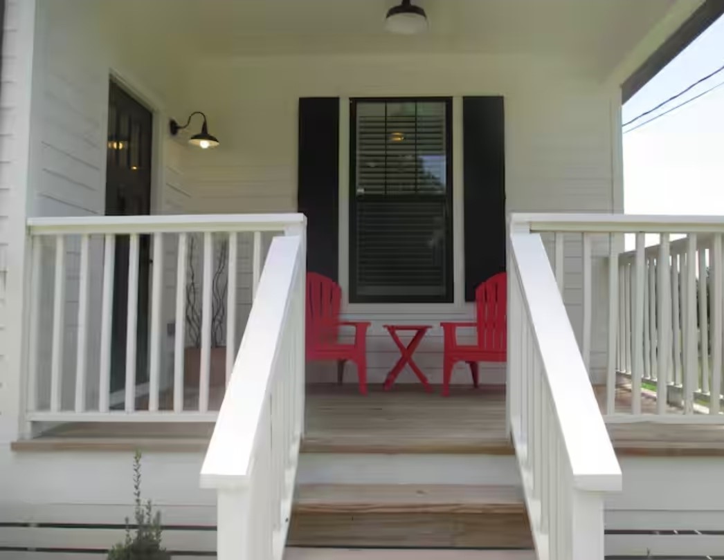 704 Burleson Street Brenham, TX 77833 - Photo 25 of 28 a view of staircase with railing and a rug