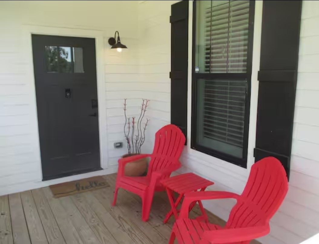 704 Burleson Street Brenham, TX 77833 - Photo 26 of 28 a view of a balcony with furniture and wooden floor