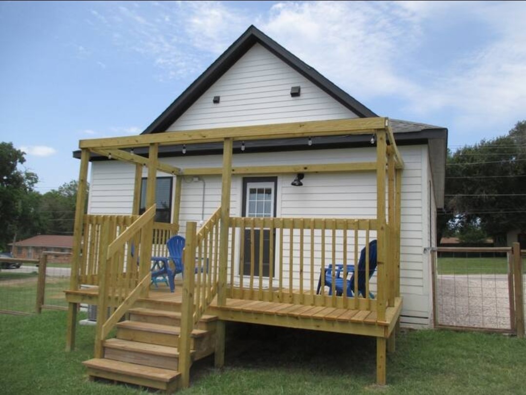 704 Burleson Street Brenham, TX 77833 - Photo 28 of 28 a front view of a house with a garden and patio