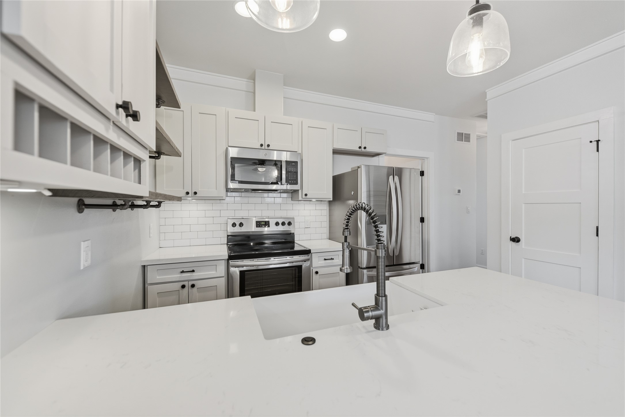 704 Burleson Street Brenham, TX 77833 - Photo 6 of 28 a kitchen with stainless steel appliances a refrigerator stove microwave and sink