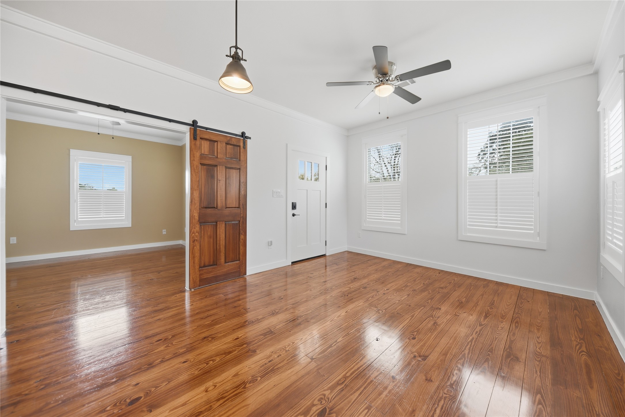 704 Burleson Street Brenham, TX 77833 - Photo 9 of 28 a view of empty room with wooden floor and fan