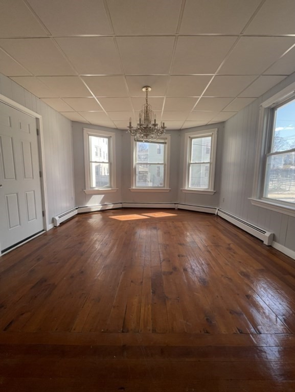 4 Conduit Street, Unit 1 Lawrence, MA 01841 - Photo 11 of 14 an empty room with wooden floor and windows