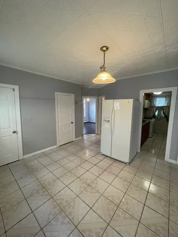 a view of a refrigerator and window in a room