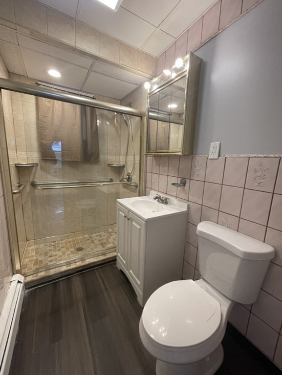 4 Conduit Street, Unit 1 Lawrence, MA 01841 - Photo 7 of 14 a bathroom with a toilet sink and mirror