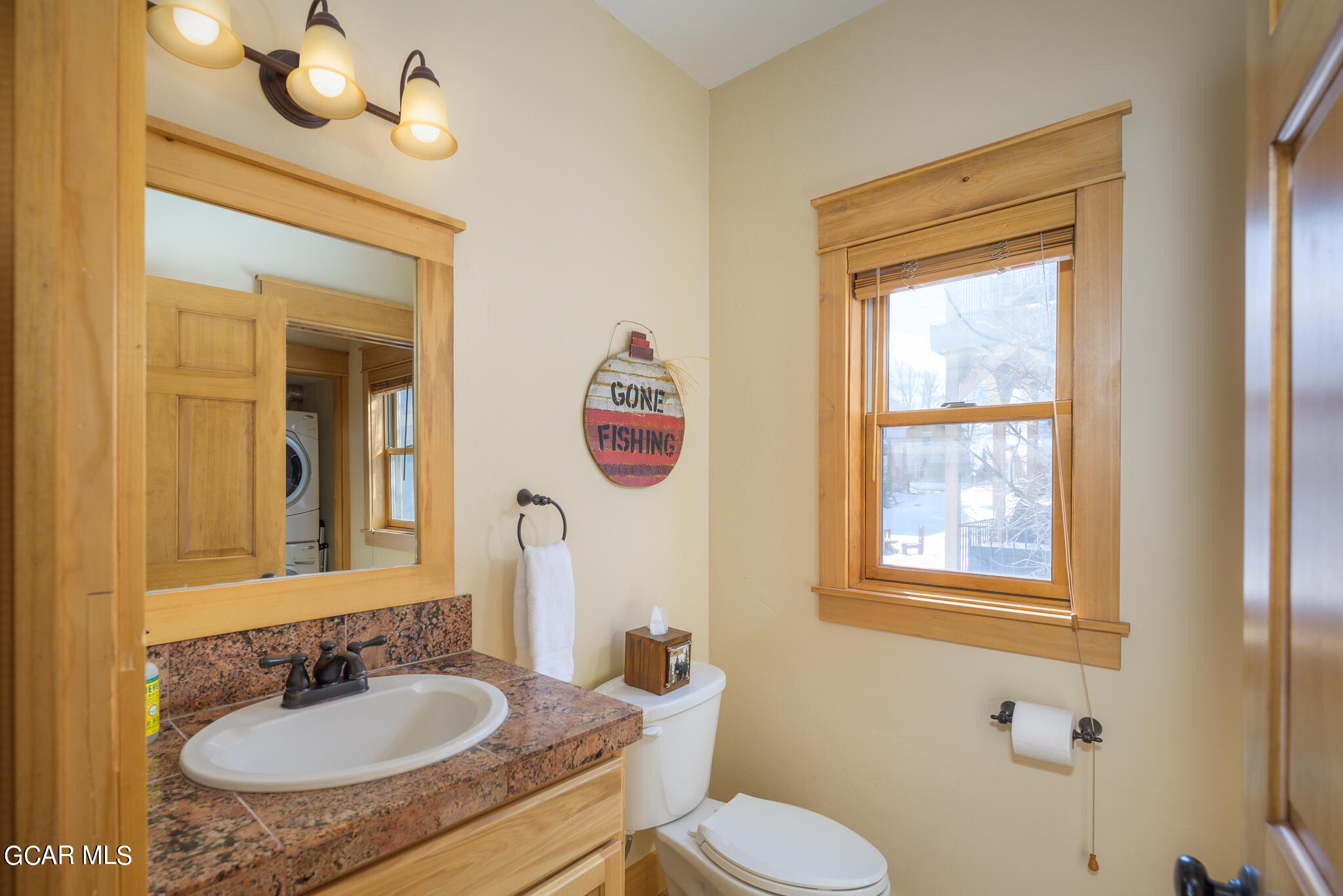 129 Edgewater Circle Granby, CO 80446 - Photo 13 of 63 a bathroom with a granite countertop sink and a mirror