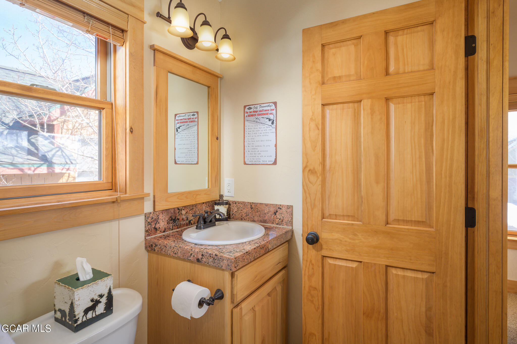 129 Edgewater Circle Granby, CO 80446 - Photo 17 of 63 a bathroom with a sink a vanity and a window