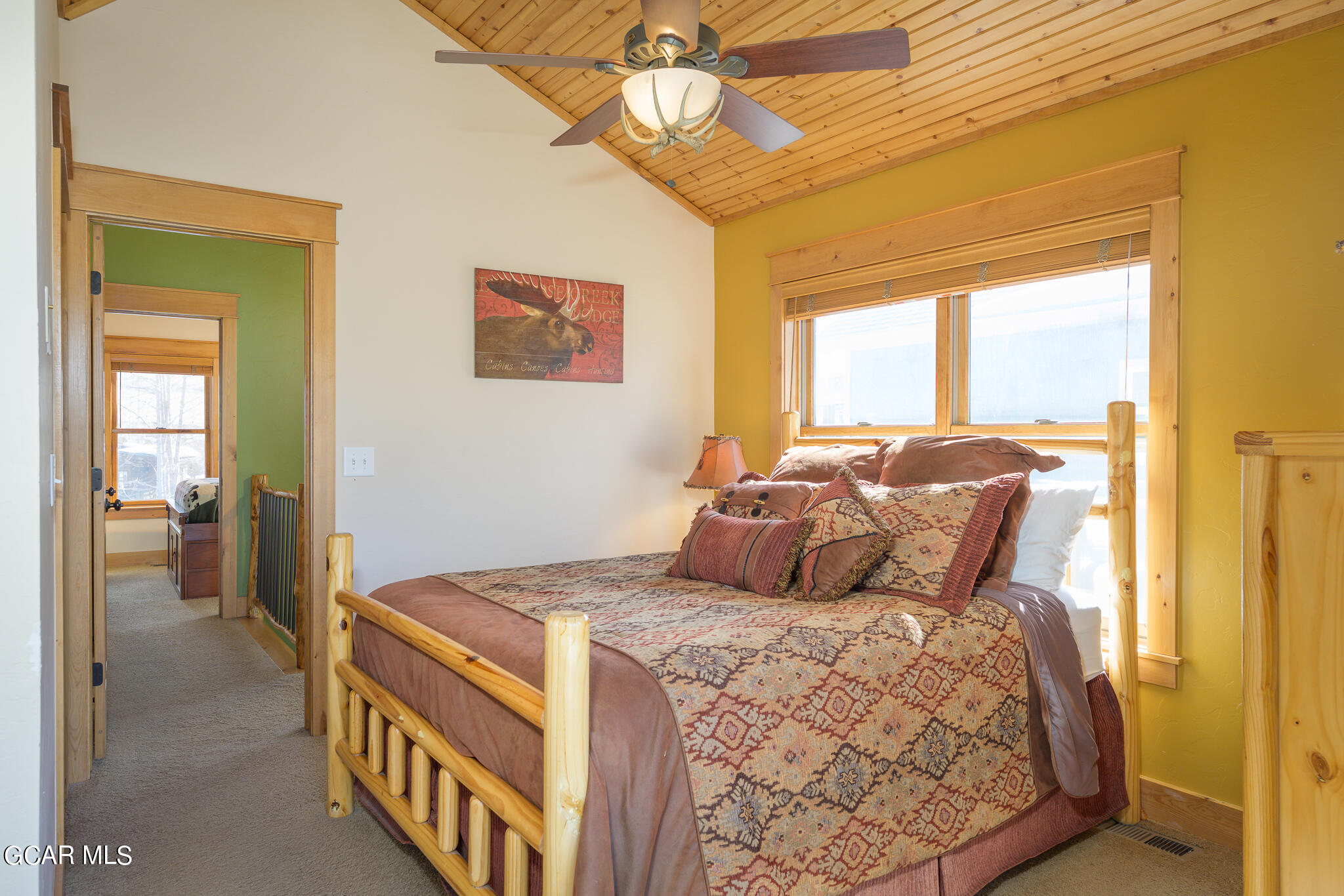 129 Edgewater Circle Granby, CO 80446 - Photo 20 of 63 a bedroom with a bed and a chandelier
