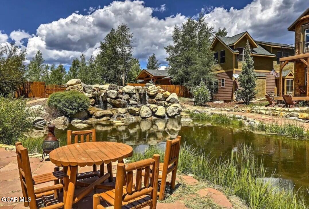 129 Edgewater Circle Granby, CO 80446 - Photo 29 of 63 a view of a lake with a table and chairs