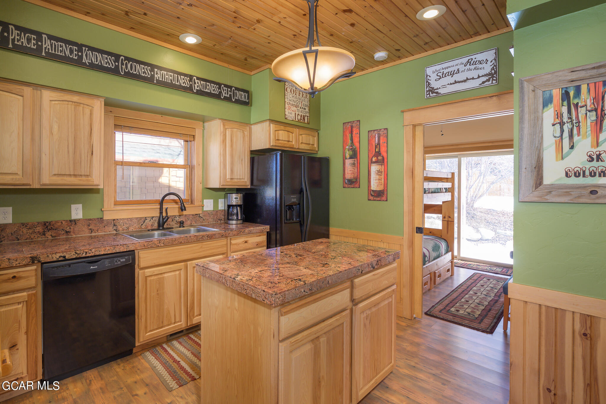 129 Edgewater Circle Granby, CO 80446 - Photo 6 of 63 a kitchen with kitchen island granite countertop a sink cabinets and refrigerator
