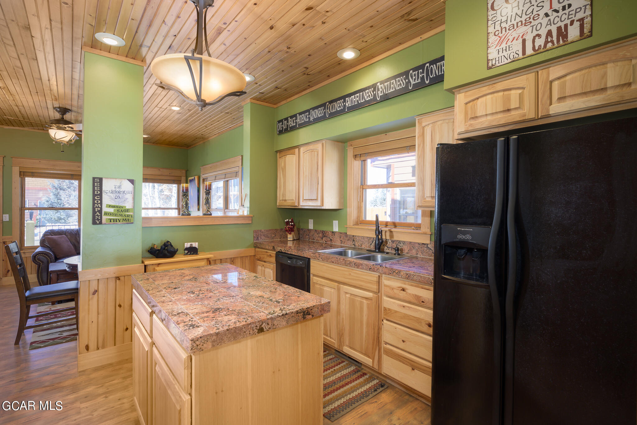 129 Edgewater Circle Granby, CO 80446 - Photo 8 of 63 a kitchen with a stove a refrigerator and a dining table with wooden floor
