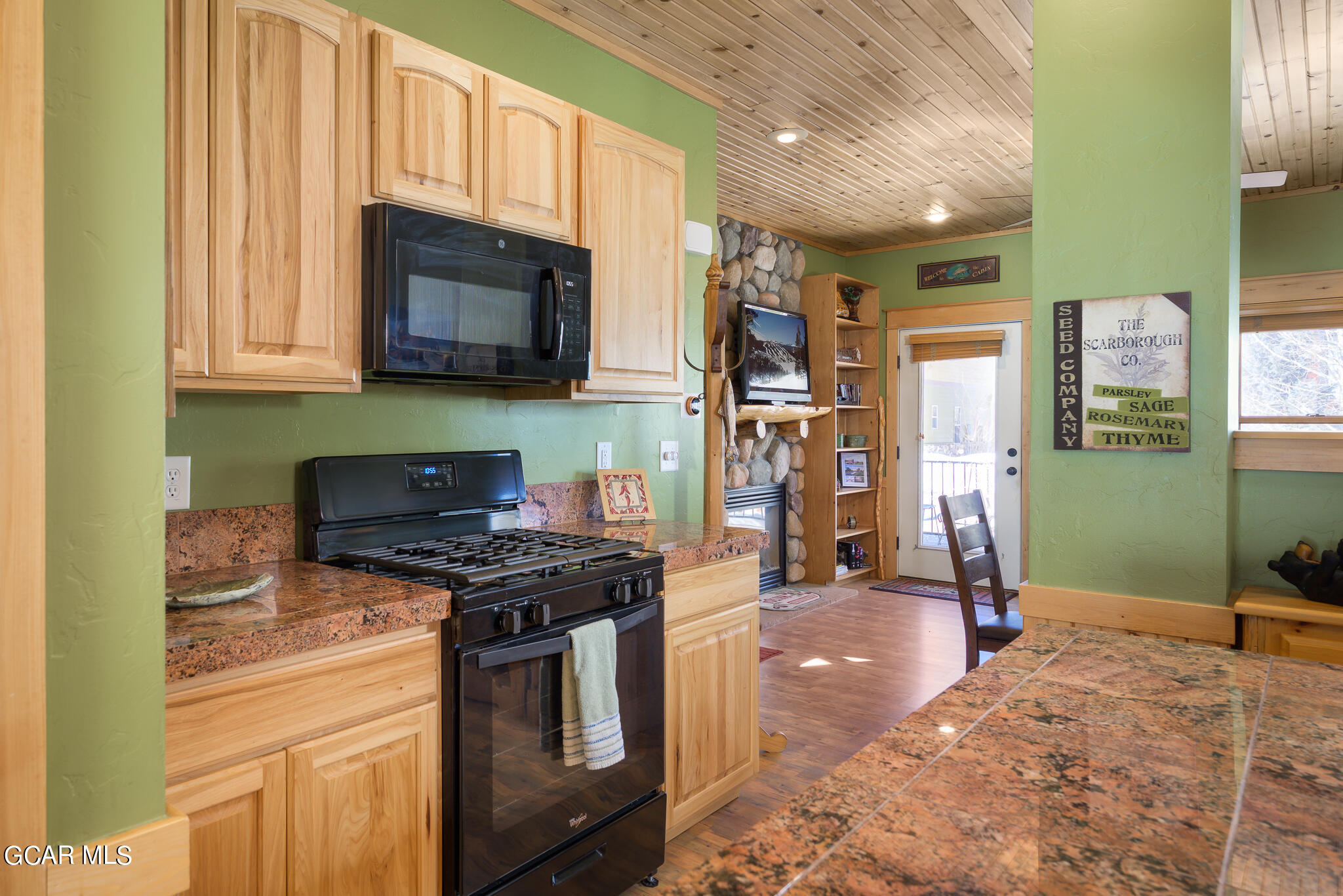 129 Edgewater Circle Granby, CO 80446 - Photo 9 of 63 a kitchen with stainless steel appliances granite countertop a stove a sink and a microwave