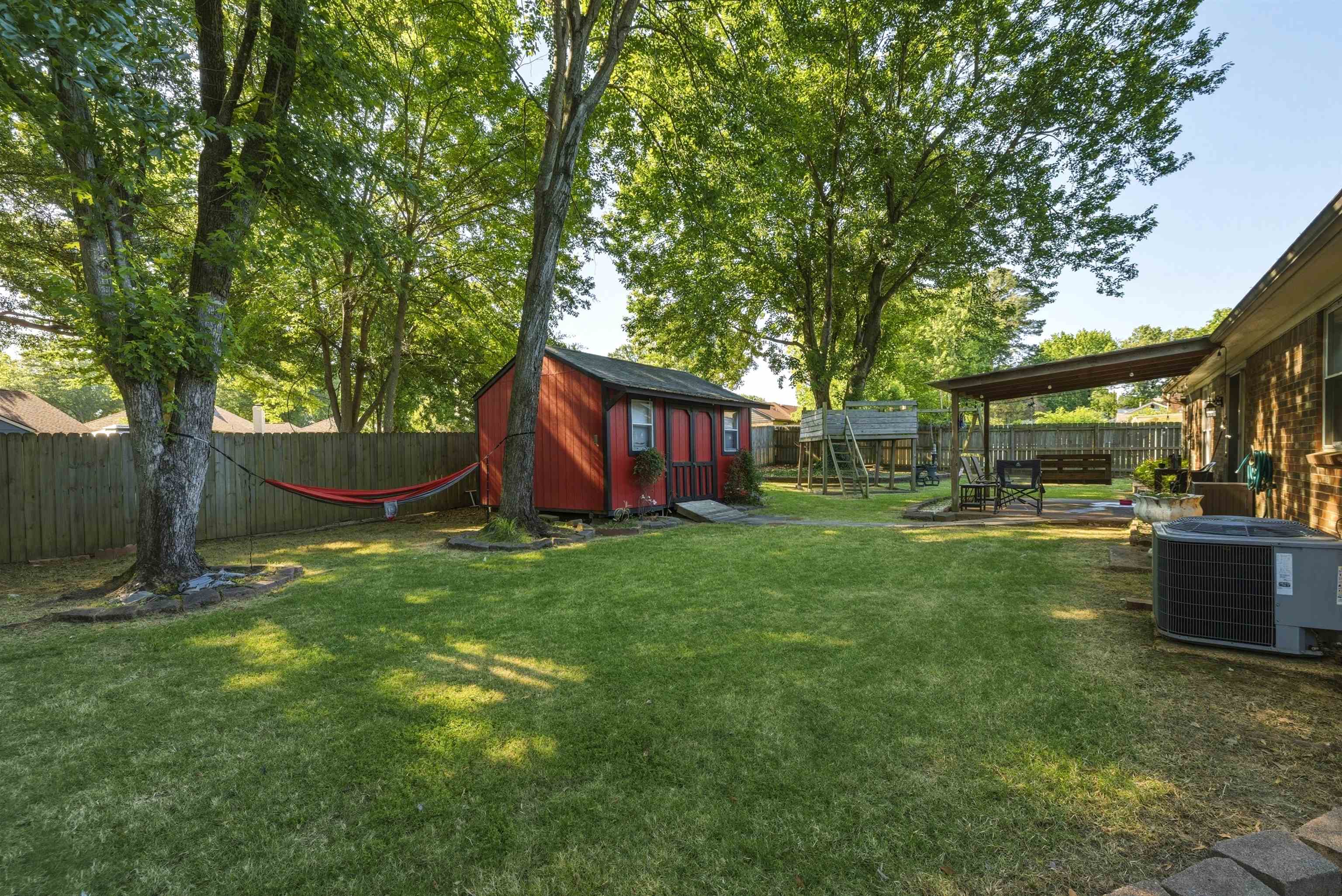 3276 Altruria Road Bartlett, TN 38134 - Photo 20 of 30 Expansive green lawn featuring mature trees and a privacy fence