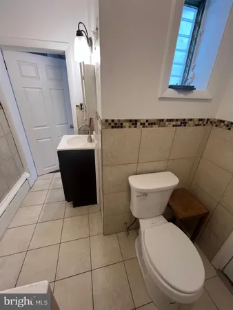 a bathroom with a toilet and a mirror