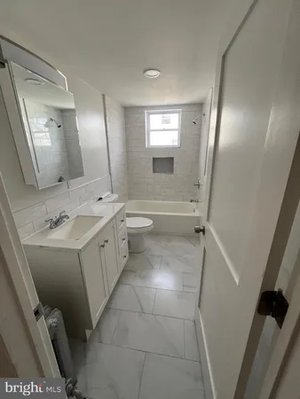 a bathroom with a sink a toilet and mirror