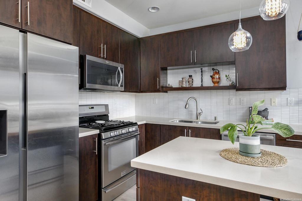 2256 Indus Way San Marcos, CA 92078 - Photo 1 of 1 a kitchen with a sink cabinets and stainless steel appliances