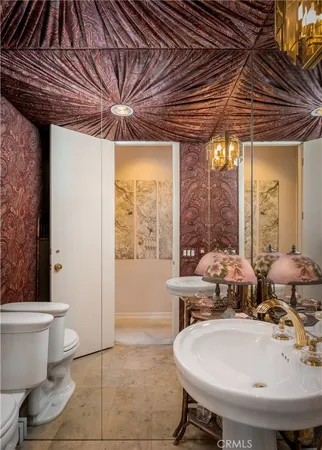 a bathroom with a sink mirror and toilet