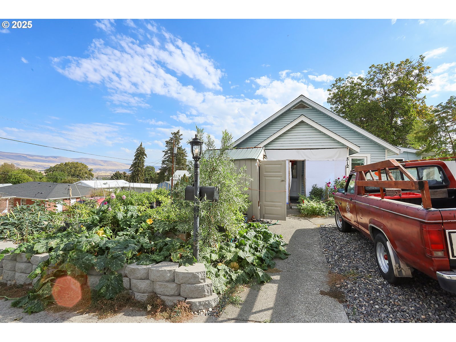 812 East 15th Street The Dalles, OR 97058 - Photo 3 of 41 a view of a house with a yard and potted plants