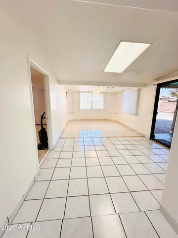 a view of a livingroom with an empty space and a window