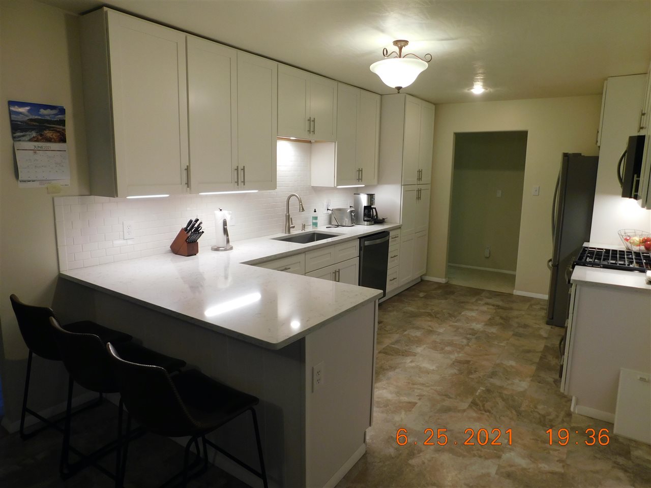 705 Ash Drive Grand Junction, CO 81506 - Photo 18 of 21 a kitchen with kitchen island a sink stove and refrigerator