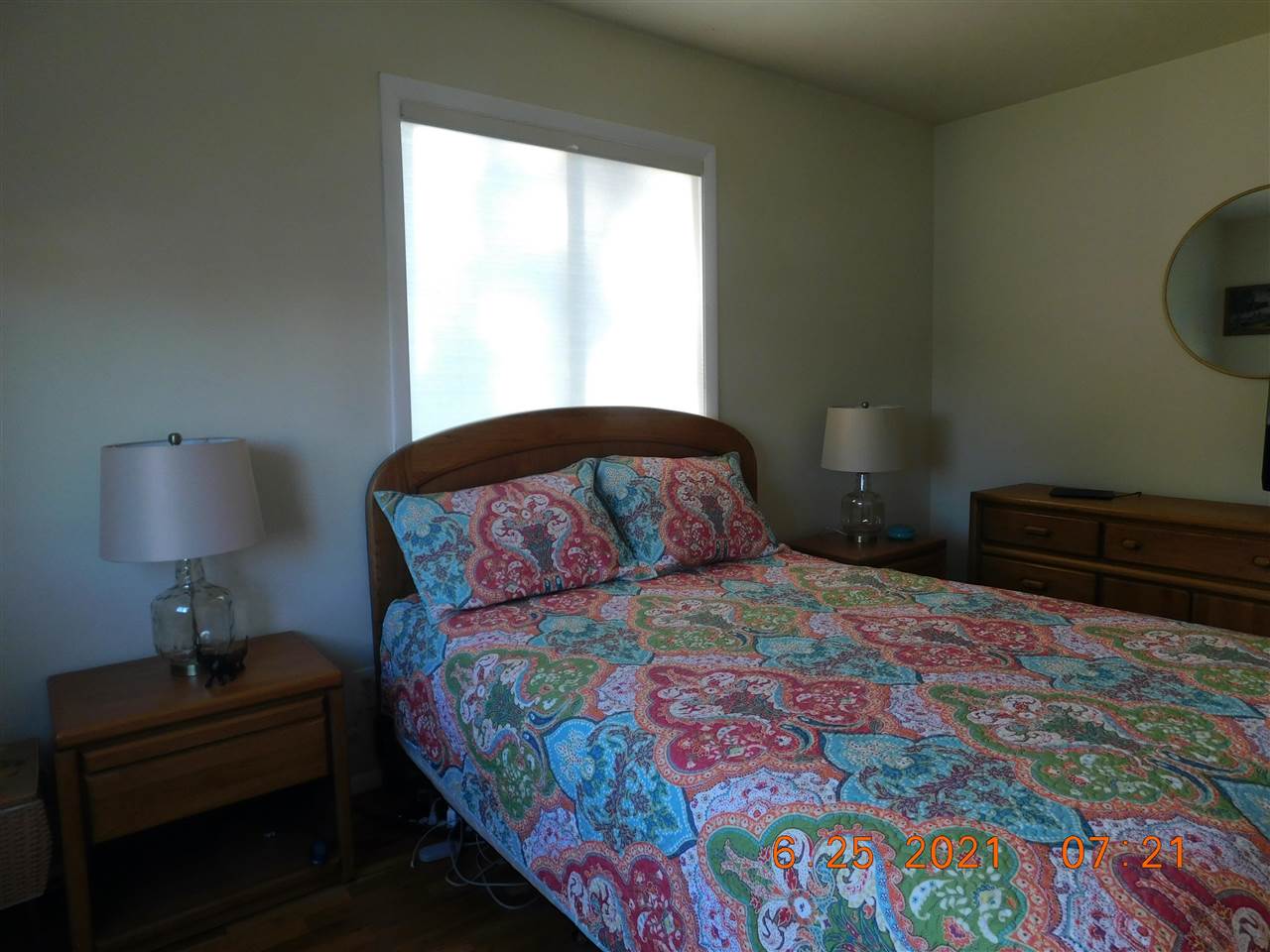 705 Ash Drive Grand Junction, CO 81506 - Photo 5 of 21 a bedroom with a bed lamp and a window