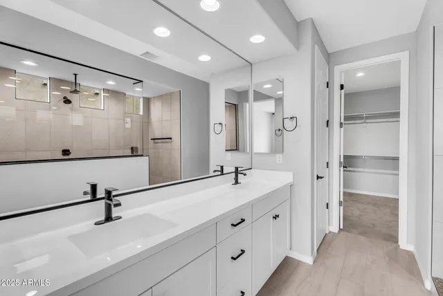 a bathroom with a double vanity sink mirror and double