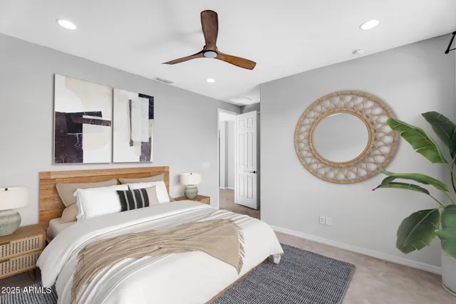 a bedroom with a bed and a mirror