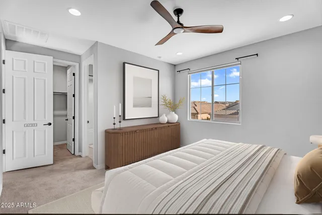 a bedroom with a bed and a large window