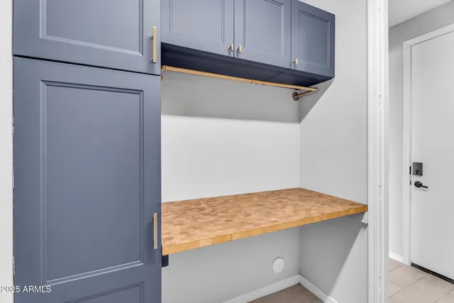 a view of storage and utility room with wooden floor