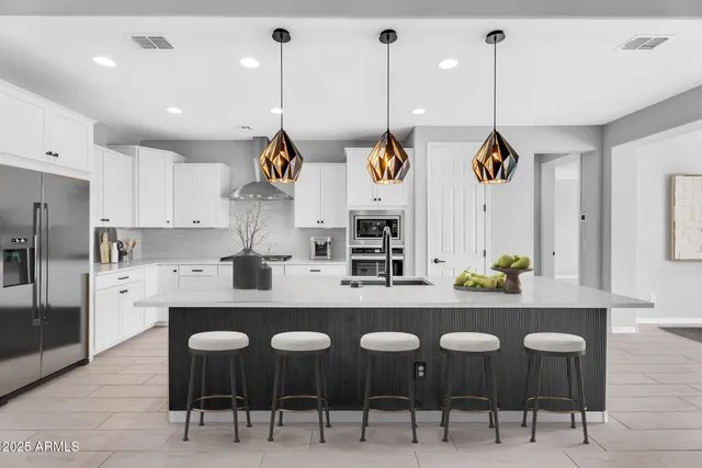 a large kitchen with a table and chairs