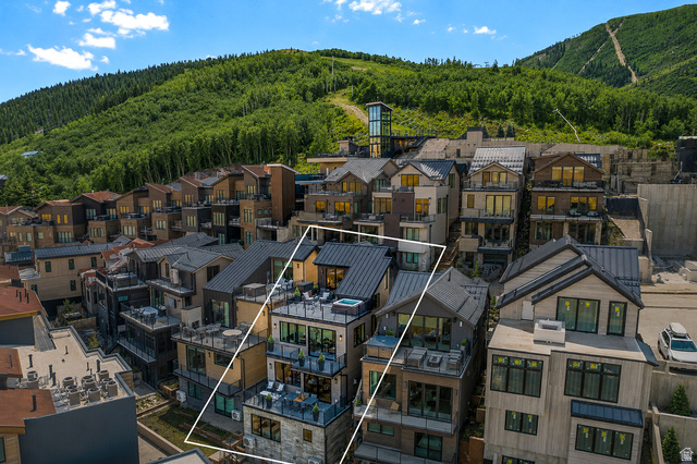 1258 Rothwell Road Park City, UT 84060 - Photo 4 of 48 Multi-story townhouse featuring multiple balconies with glass railings, a rooftop terrace with a hot tub, and a dark metal roof