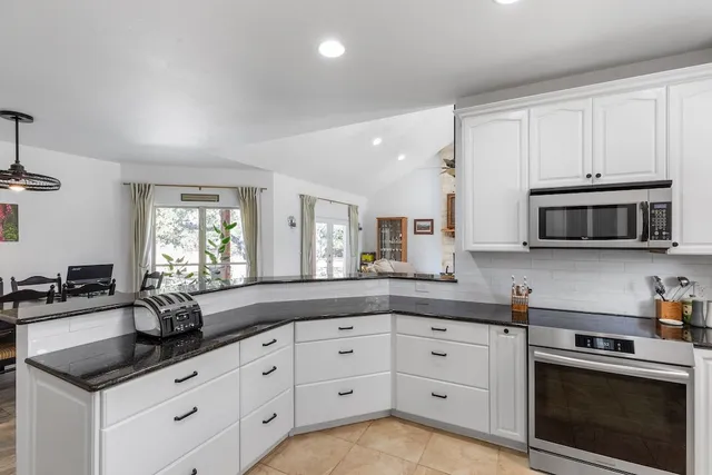 a kitchen with stainless steel appliances a refrigerator sink and cabinets