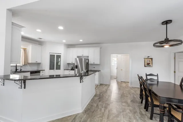 a bathroom with a sink vanity granite and a mirror