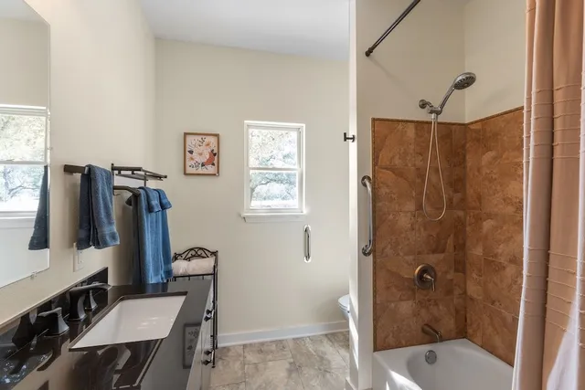 a bathroom with a bathtub and shower
