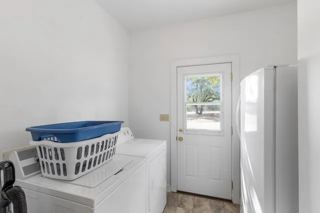 a view of a patio with table and chairs and floor to ceiling window