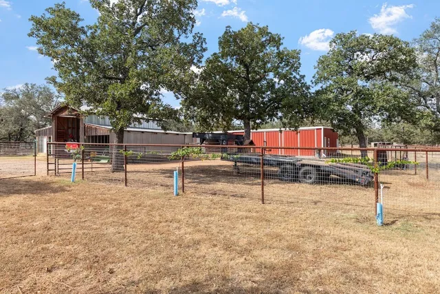 a view of a patio with table and chairs and potted plants