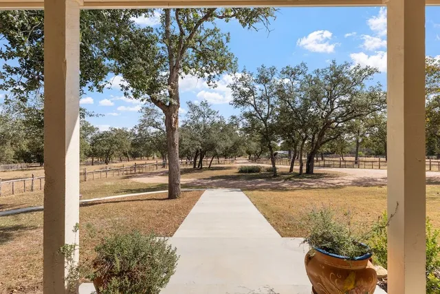 a view of a yard with fountain in front of house