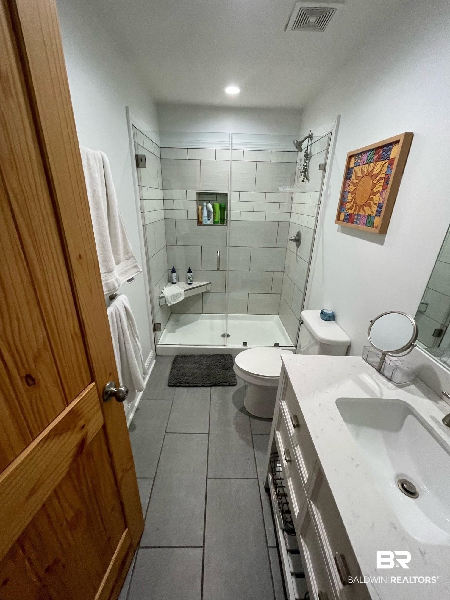 962 Savannah Street Mobile, AL 36604 - Photo 6 of 7 Bathroom featuring tile patterned flooring, vanity, toilet, and a shower with shower door