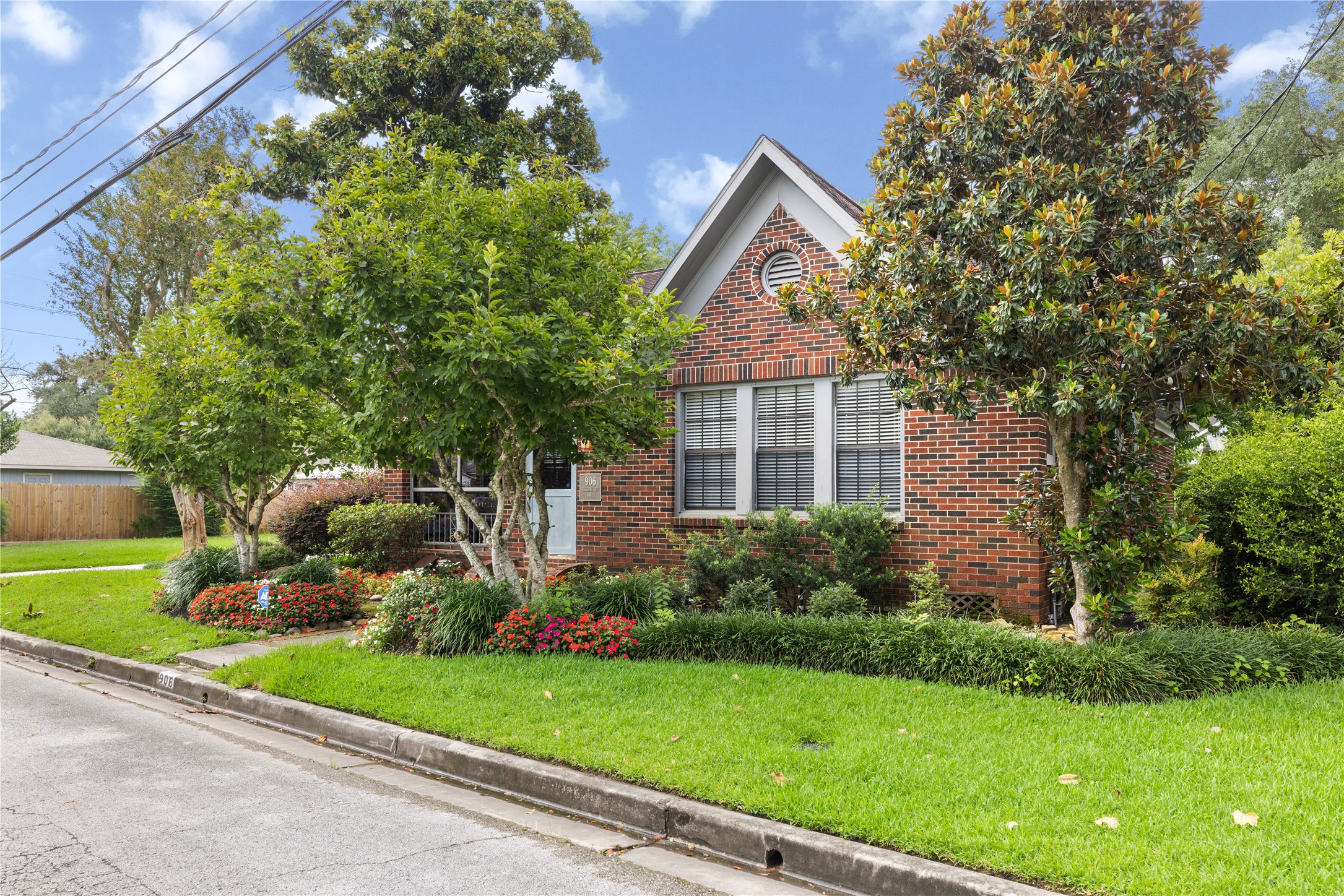 906 Higgins Street Humble, TX 77338 - Photo 2 of 26 Welcome to 906 Higgins. The exterior includes large windows, a peaked roof and enclosed climate controlled front porch, creating a welcoming curb appeal.