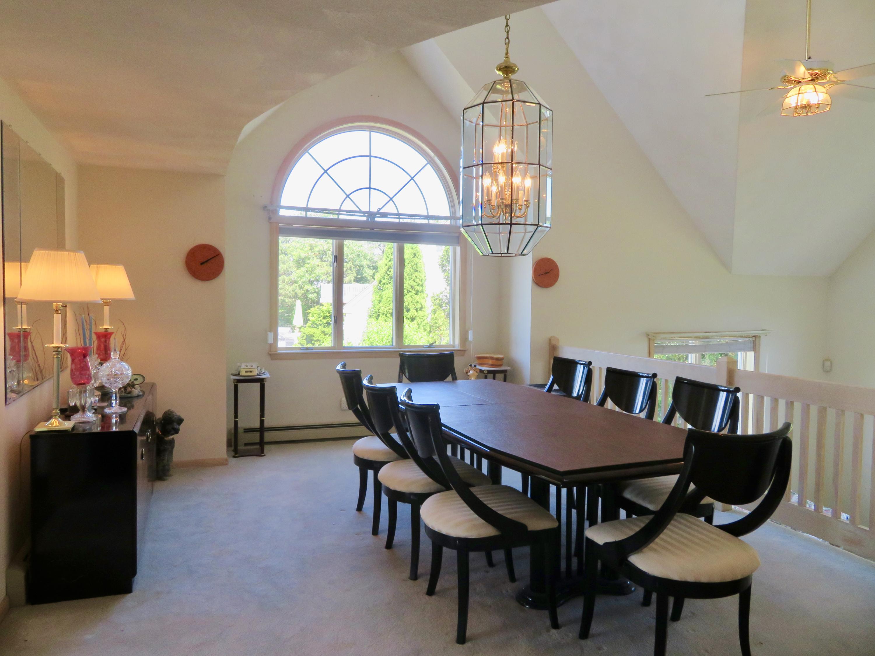 19 Long Boat Road Bourne, MA 02532 - Photo 11 of 33 a view of a dining room with furniture and a chandelier