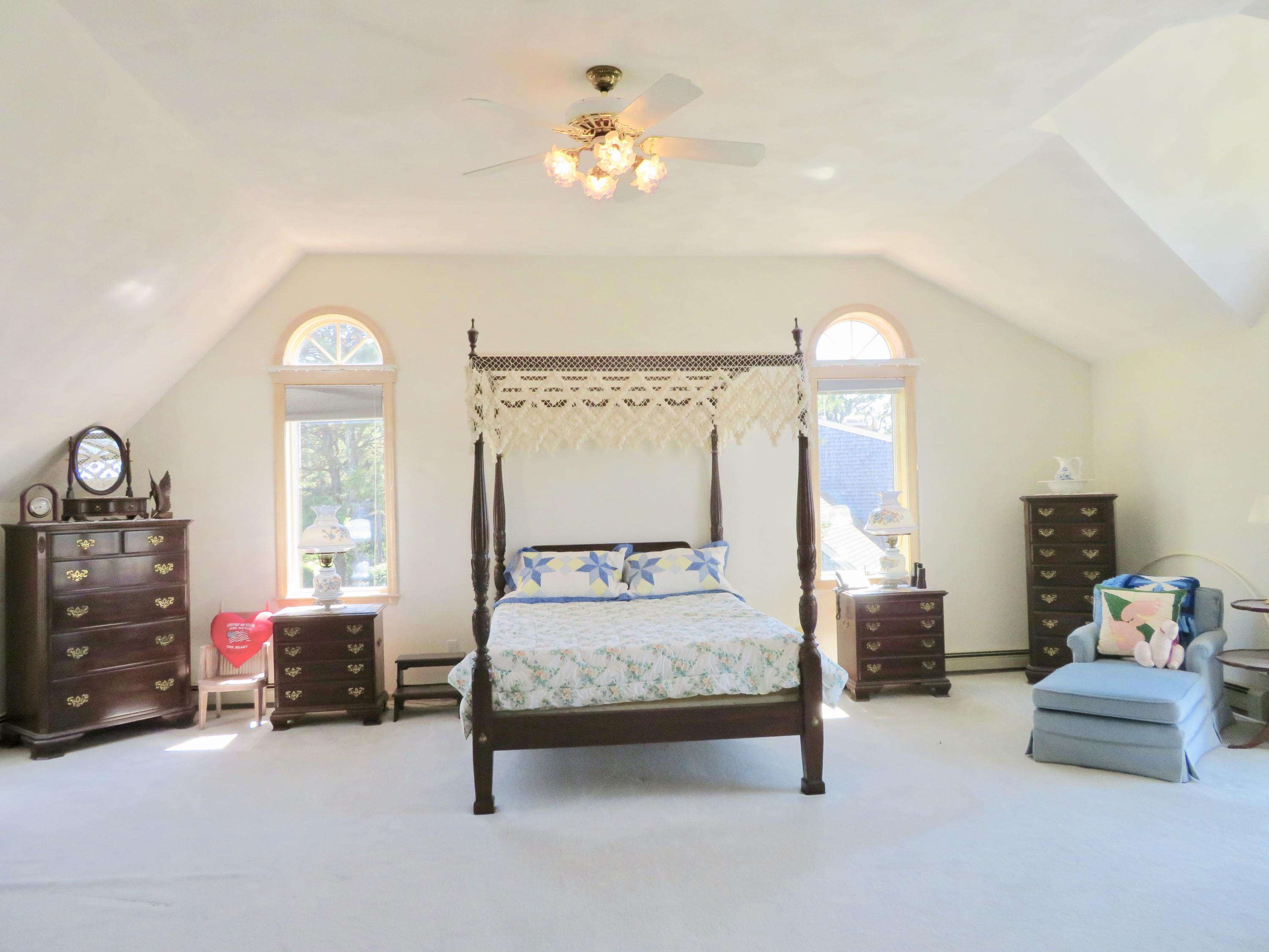 19 Long Boat Road Bourne, MA 02532 - Photo 14 of 33 a bedroom with furniture and a large mirror