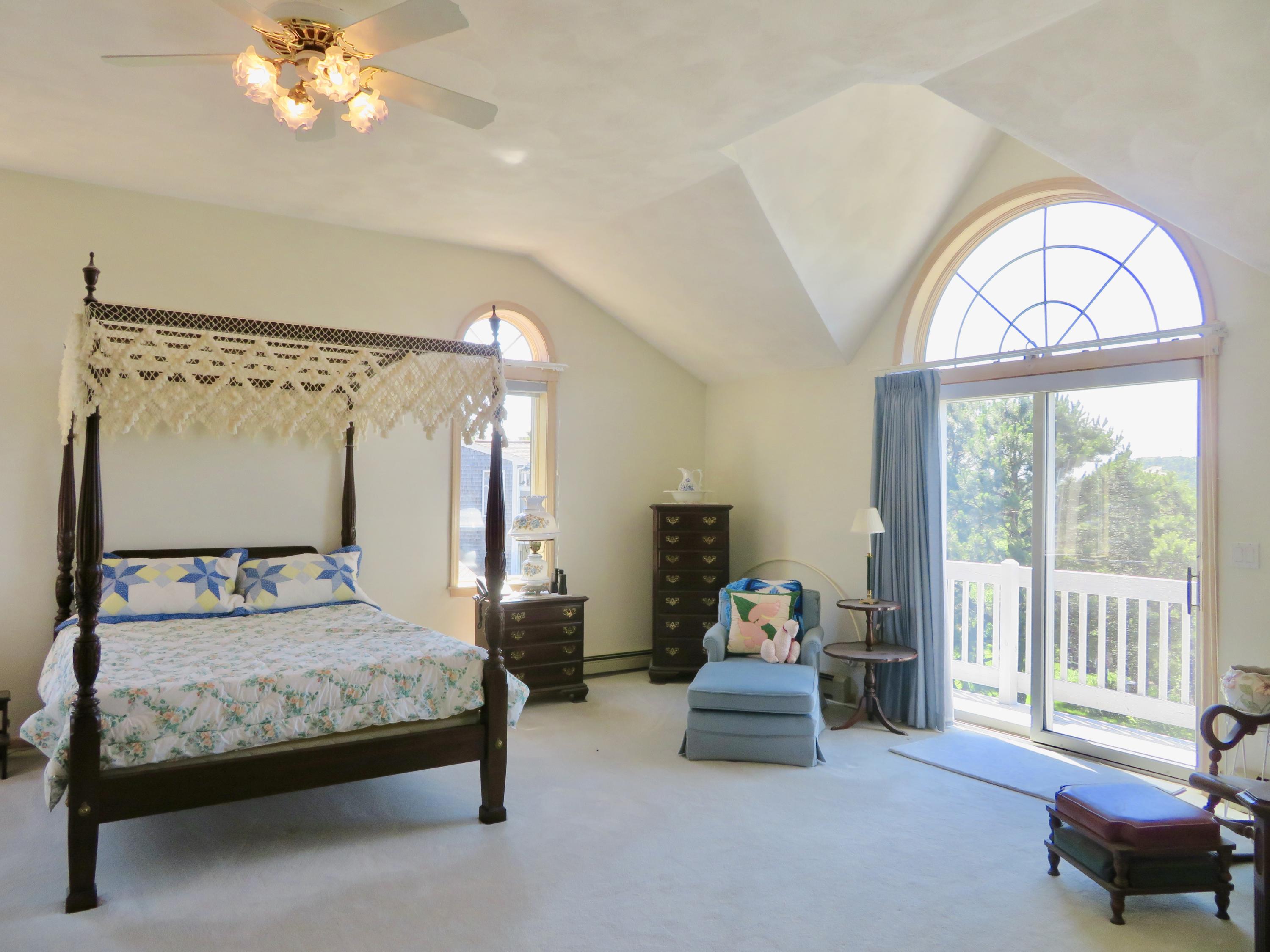 19 Long Boat Road Bourne, MA 02532 - Photo 15 of 33 a bedroom with a bed and large windows