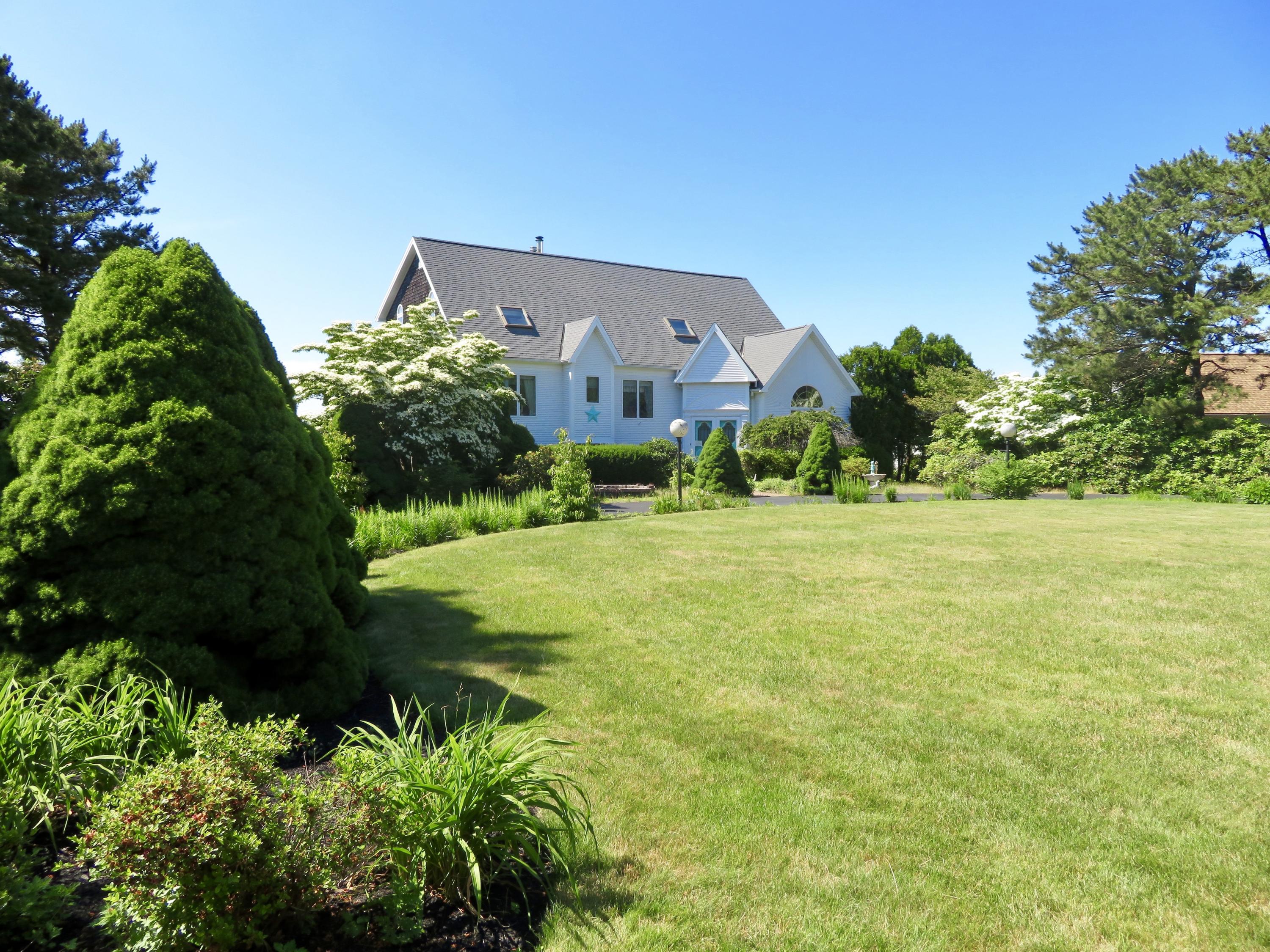 19 Long Boat Road Bourne, MA 02532 - Photo 20 of 33 a front view of a house with a yard