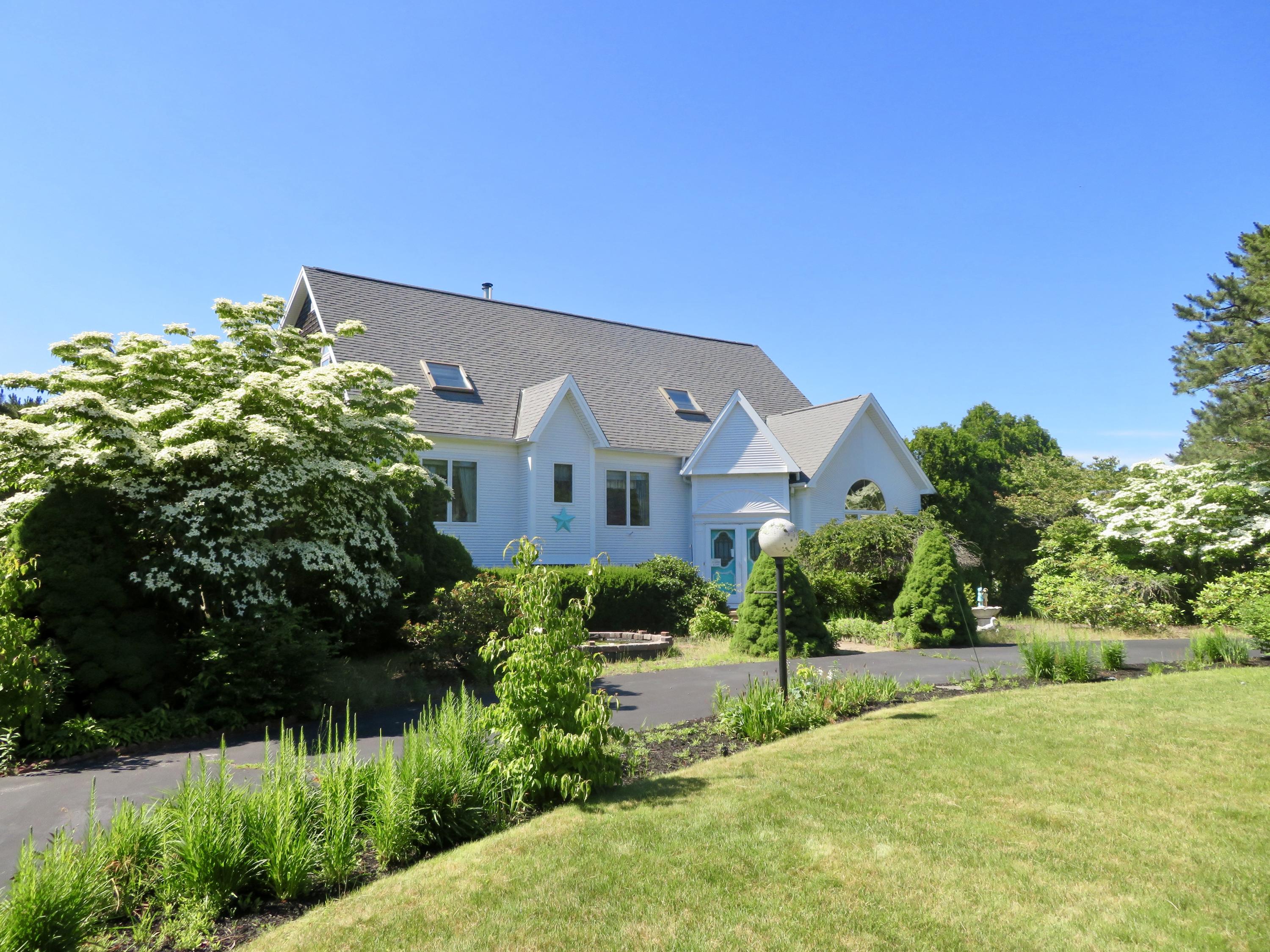 19 Long Boat Road Bourne, MA 02532 - Photo 21 of 33 a front view of a house with a yard