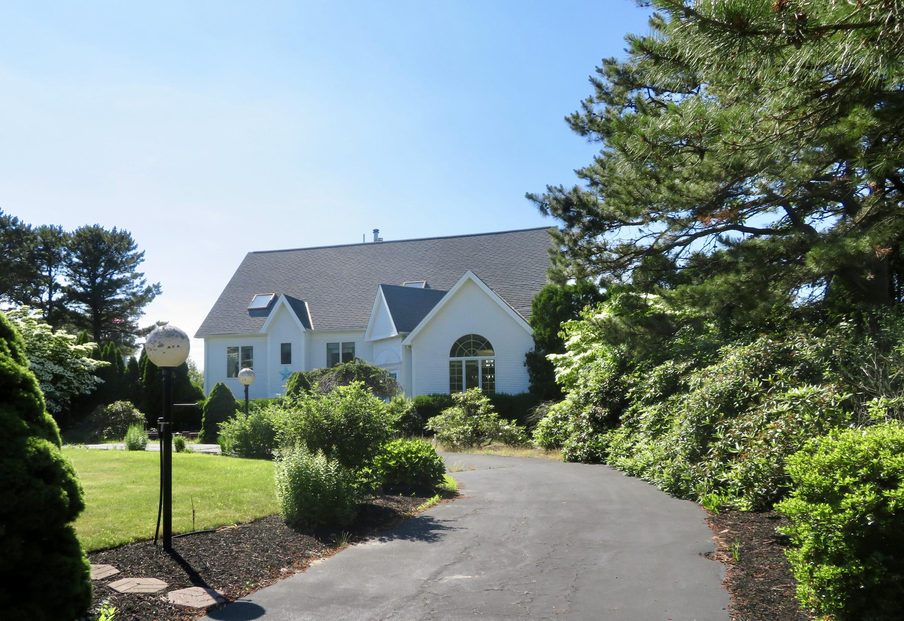 19 Long Boat Road Bourne, MA 02532 - Photo 22 of 33 a front view of a house with a garden