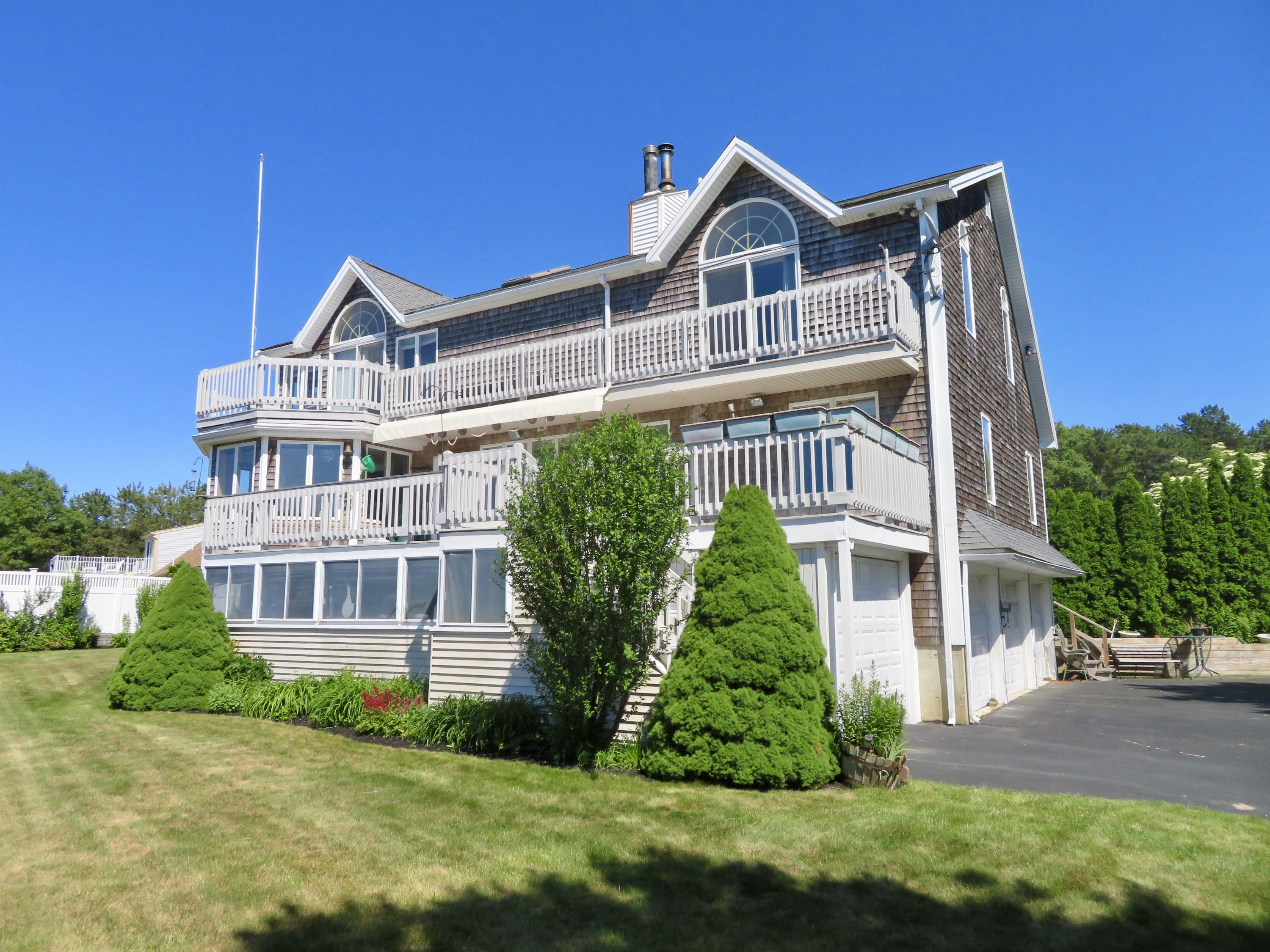 19 Long Boat Road Bourne, MA 02532 - Photo 25 of 33 a front view of a house with a yard
