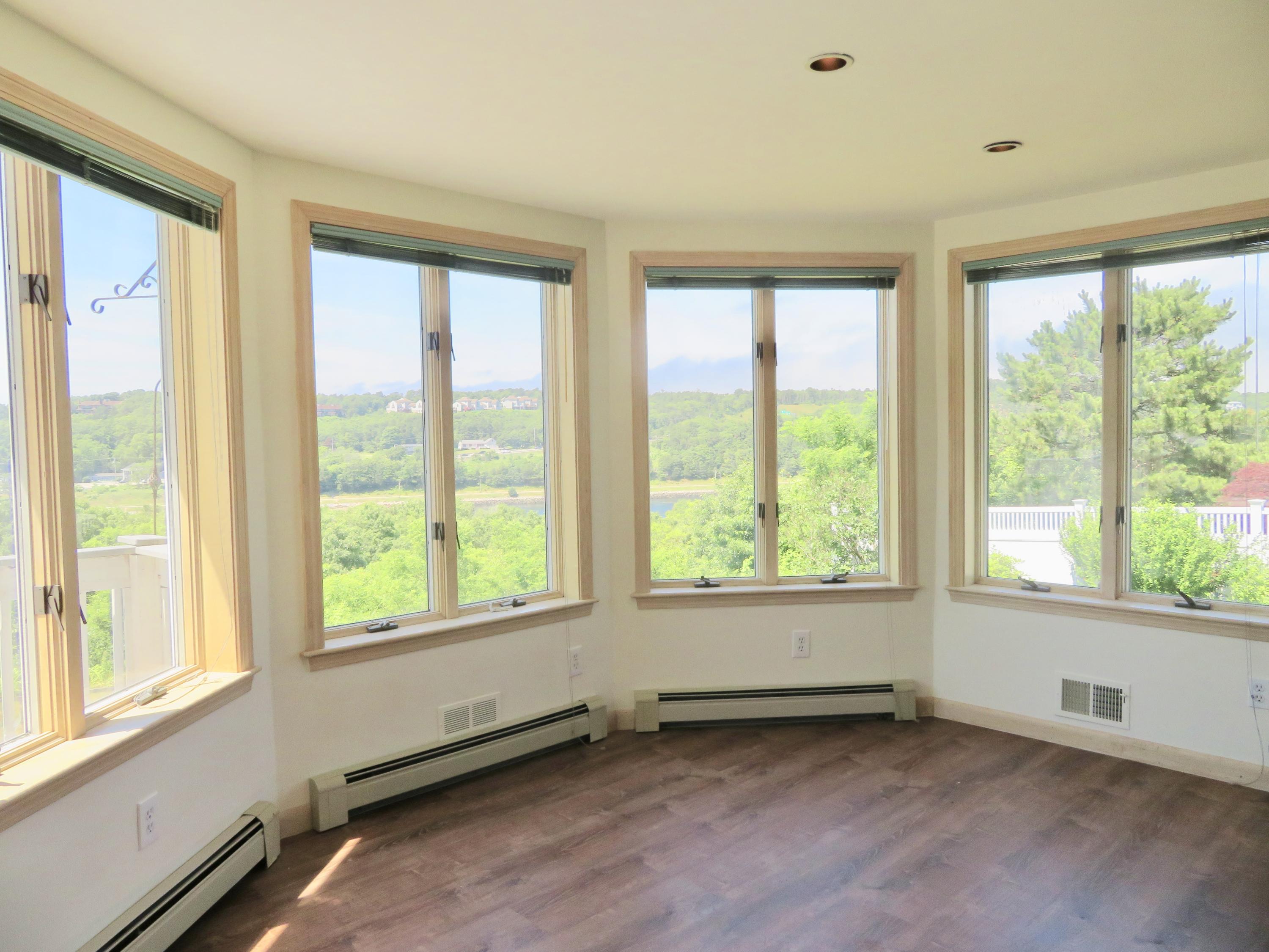 19 Long Boat Road Bourne, MA 02532 - Photo 7 of 33 a view of an empty room with a window and wooden floor
