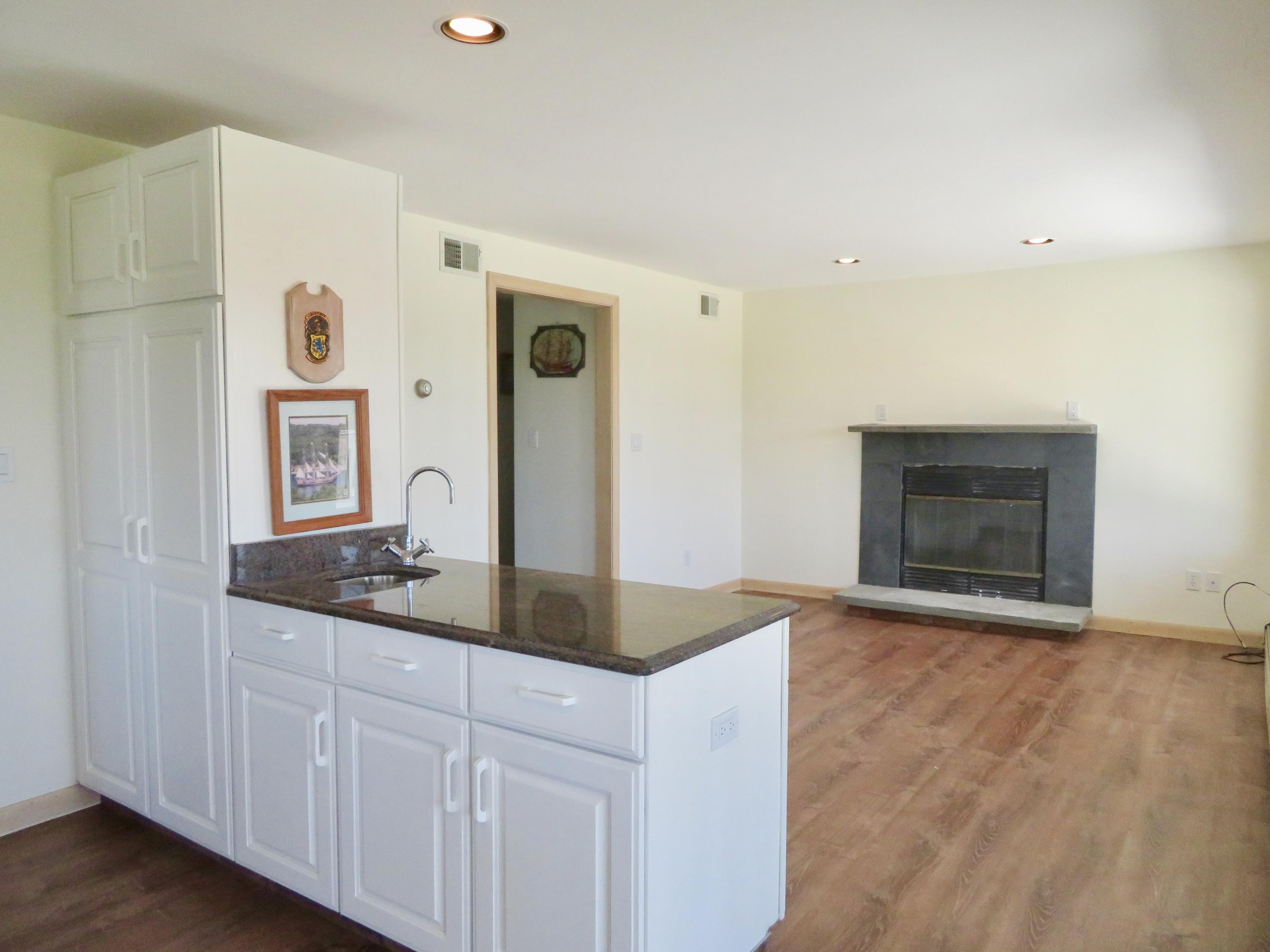 19 Long Boat Road Bourne, MA 02532 - Photo 9 of 33 a bathroom with a granite countertop sink and a mirror