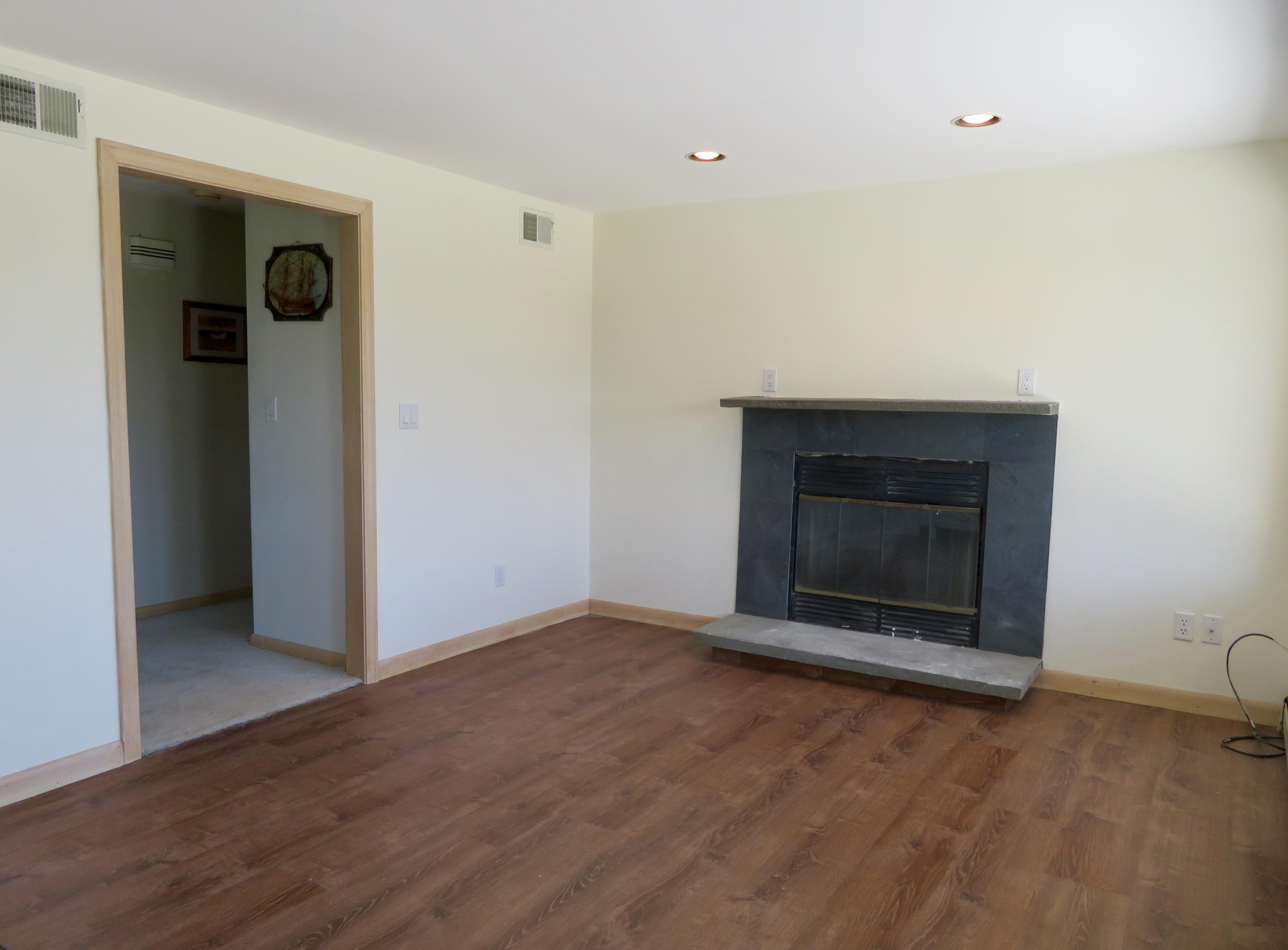 19 Long Boat Road Bourne, MA 02532 - Photo 10 of 33 an empty room with wooden floor a fireplace