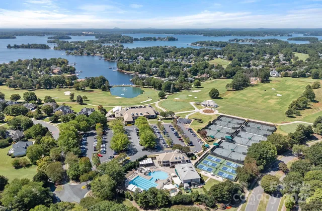 an aerial view of a house with a mountain